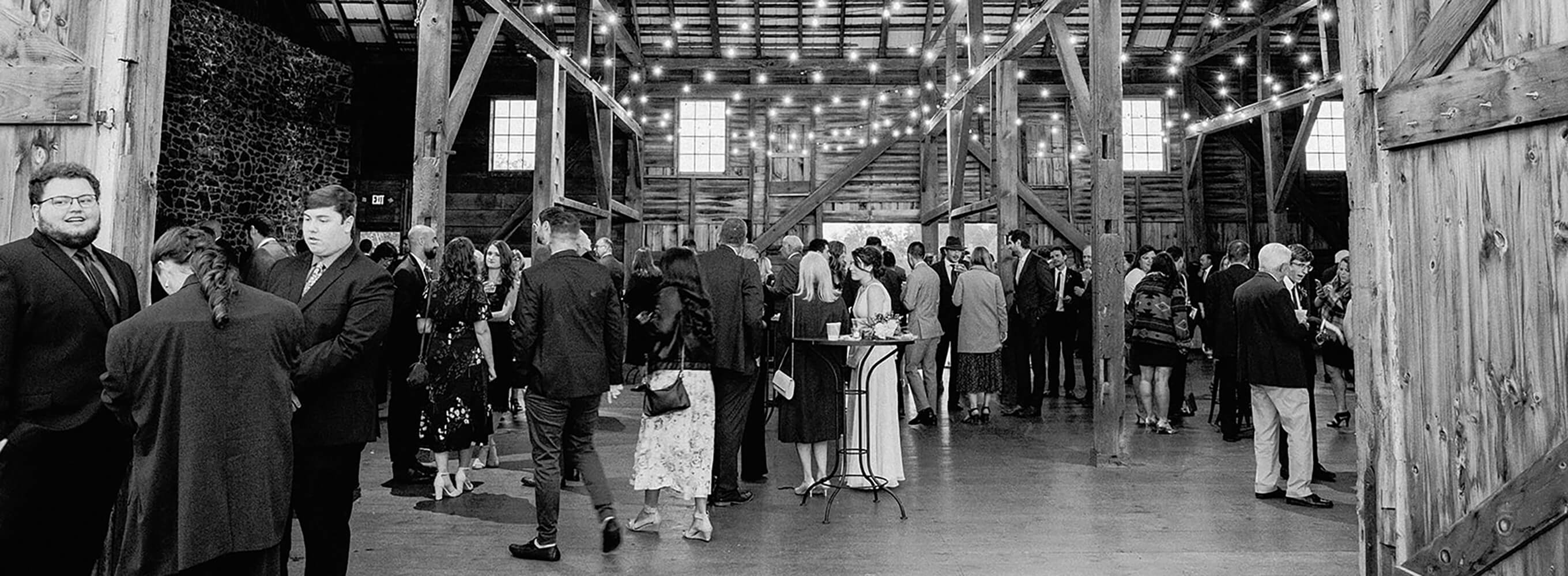 black and white image of event in barn style building