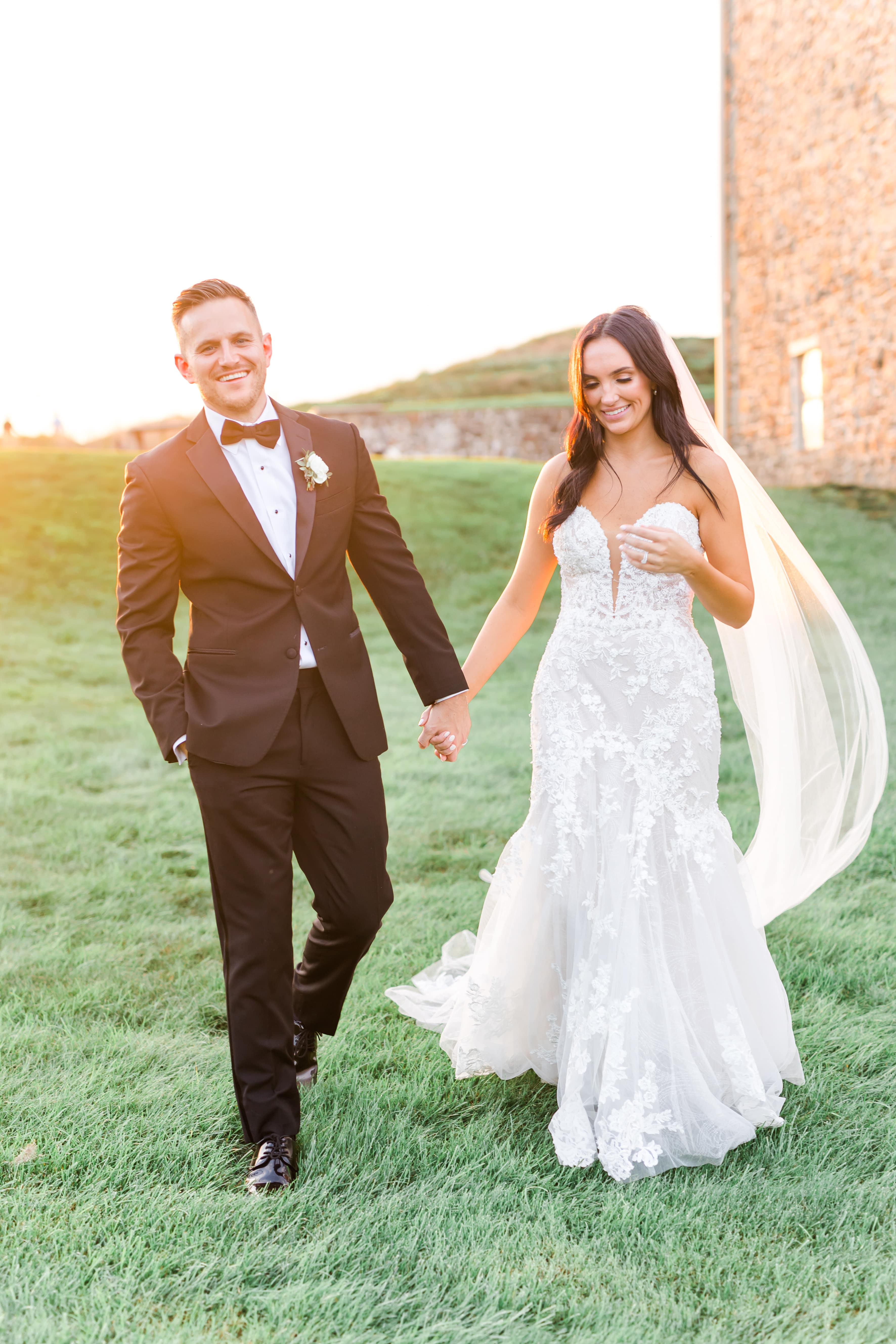 bride and groom walking holding hands