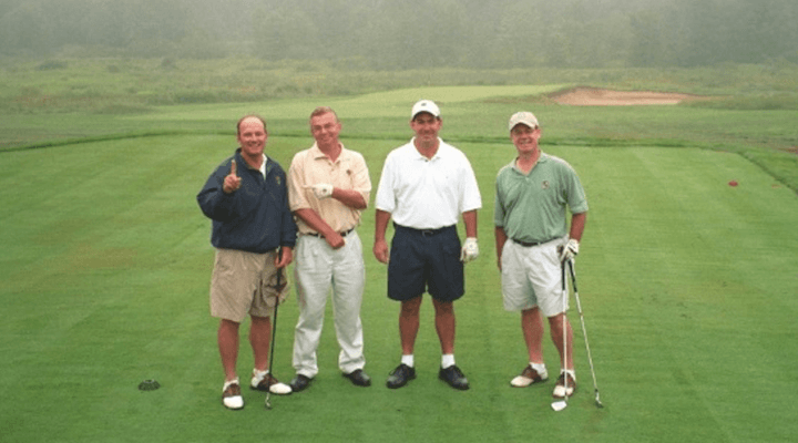 golfers posing on green